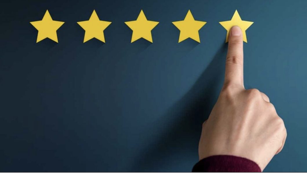 Finger pressing five star gold rating