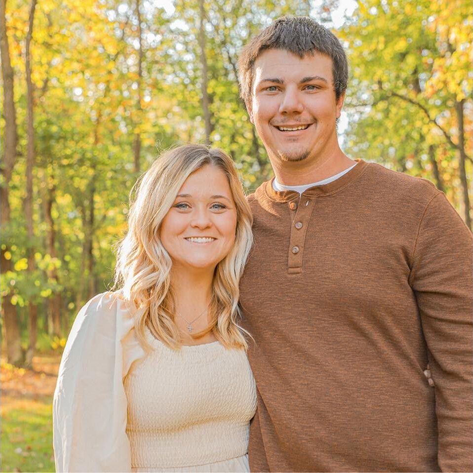 Smiling couple standing outdoors in autumn
