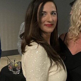 Smiling woman in white sequined dress