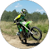 Motocross rider on green dirt bike